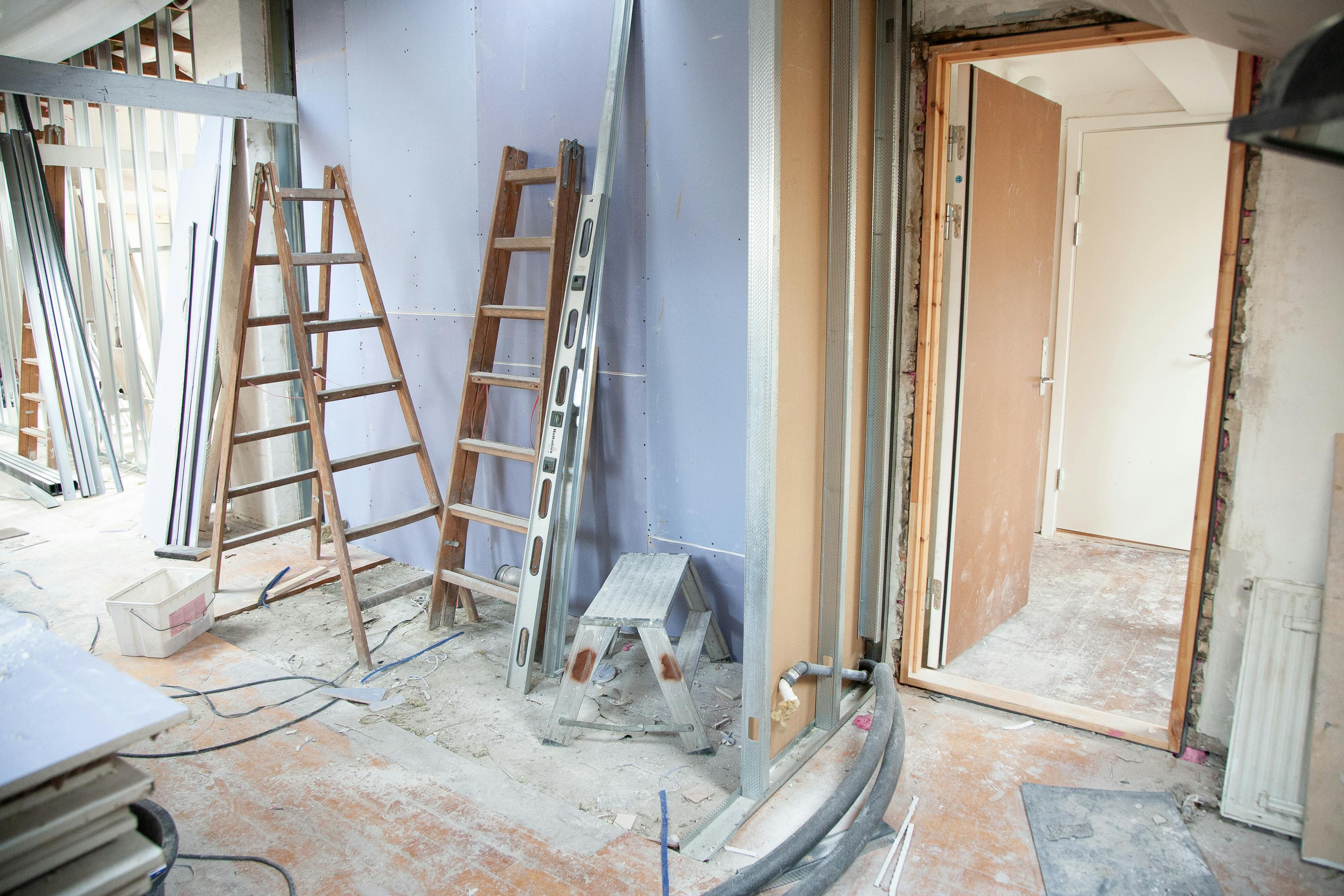 HVAC rough-in during renovation with insulated refrigerant lines and mechanical components in an active work area